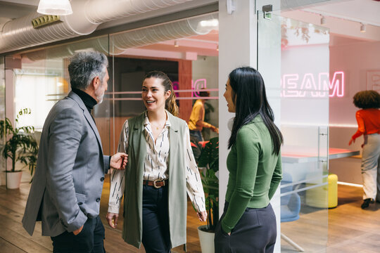Professional colleagues engaged in a lively office conversation