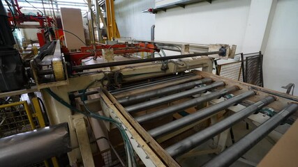 Plywood sheet that comes out of the press machine. Plywood sheets ready for sale. A factory machine that functions to clamp wood sheets for precision.