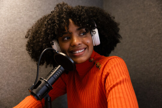 Young Woman Enjoys Podcast Recording Session in Studio