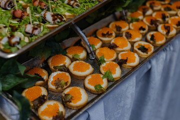 Gourmet appetizers with caviar and lettuce.