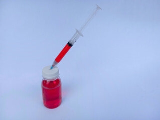 medical syringe and red liquid