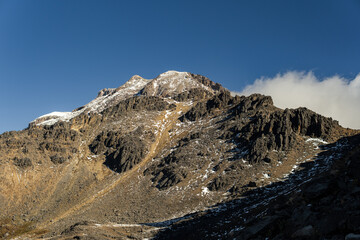 Iztaccihuatl volcano raising to the blue sky in mexico