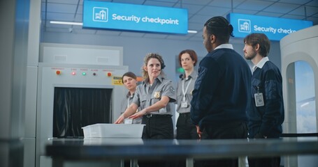 Airport Security Checkpoint: Female Security Officer Wearing Headset Instructs Airport Staff About Scanning Process on Metal Detector Conveyor Belt and TSA Screening Procedures before Boarding Flight. © Framestock