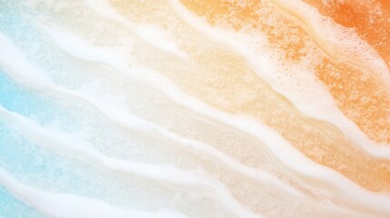 Obraz premium Waves rolling onto a sandy beach during sunset creates a beautiful blend of colors in the sky and reflections on the water