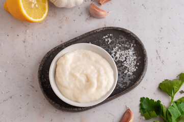 Lebanese Garlic sauce Toum or Salsat toum contains garlic, salt, olive oil and lemon juice. Traditional Middle East food. Food photography.