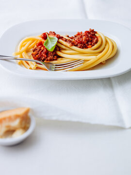 Delicious pasta Bolognese served with rich meat sauce and fresh basil