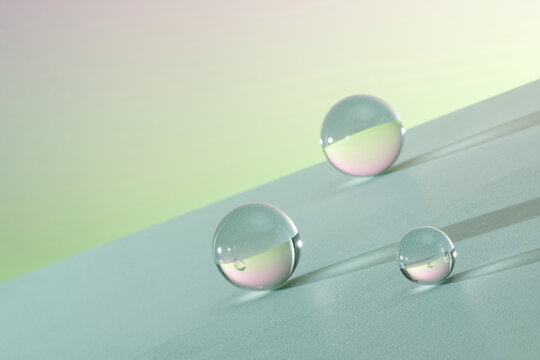 falling glass balls on light background