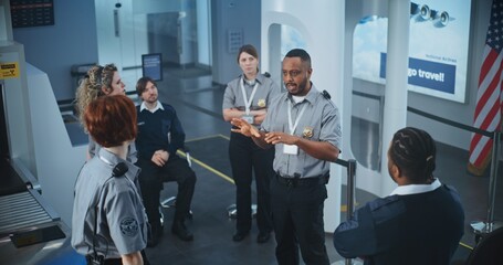 Airport Security Staff Planning Session: African American TSA Officer Holding Briefing, Providing...