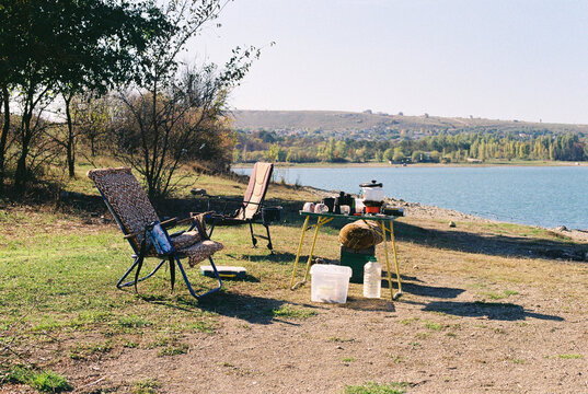 Fishing rods and fishing tackle on the lake beach. 