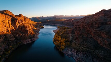 Majestic Canyon River Flowing Through Rocky Landscape with Mountains
