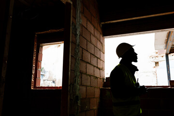 Worker inspecting the progress of the construction site