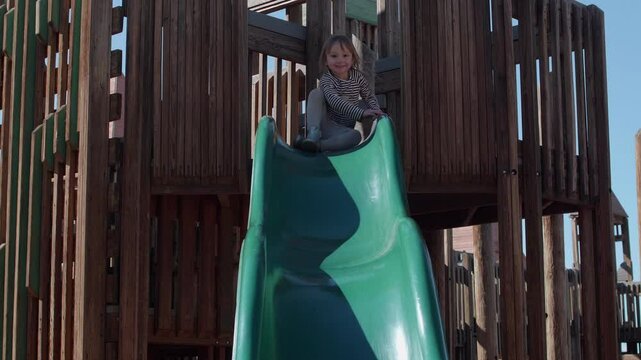 Funny Little Girl Sliding down a Slide and says Wo!