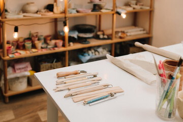 Pottery gears for molding ceramics. Set of craft sculpting tools on table in pottery workshop.