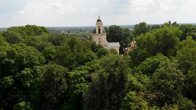 Aerial view of the golden domes and Christian cross of the Peter and Paul Cathedral in the Gomel city park
