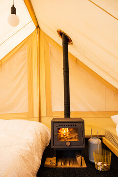 Cozy Indoor Tent with Wood Stove and Warm Light