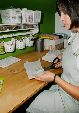 A woman cuts out a mold.