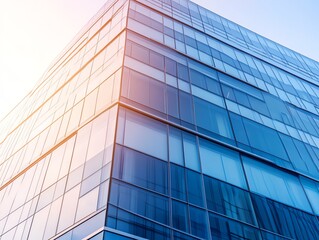 Modern glass facade of an office building with reflections on a clear day