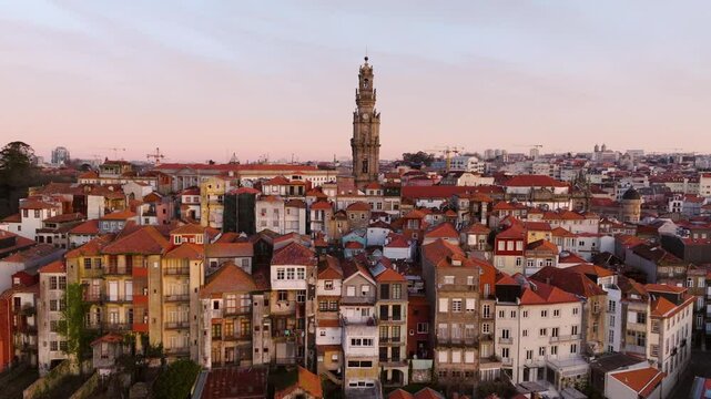 Aerial View Of Houses And Clerigos Church Tower At Sunrise In Portugal. - cinematic