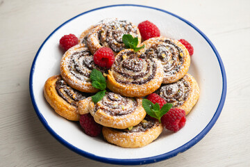 Delicious puff pastry rolls filled with cocoa cream and pistachios.