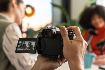 Recording podcast with digital camera capturing casual conversation