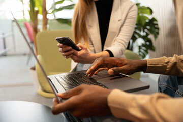 Collaborative workspace with closeup of tech and teamwork