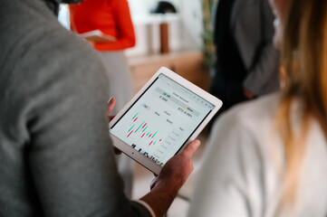 Analyzing stock market trends on a digital tablet