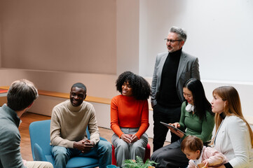 Diverse group in a casual team meeting setting with technology