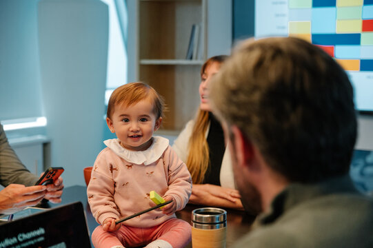 Baby in casual meeting brings joy and warmth to workspace