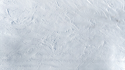 Aerial view of a snowy terrain ideal for textures, patterns and backgrounds. The white snow...