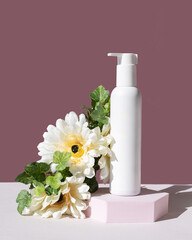 white cosmetic jar with dispenser with flowers. mockup