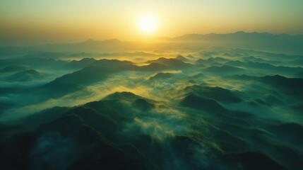 Fototapeta premium Sunrise over misty mountain range, aerial view