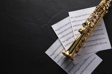 Jazz. Saxophone and music notes on black table, top view. Space for text