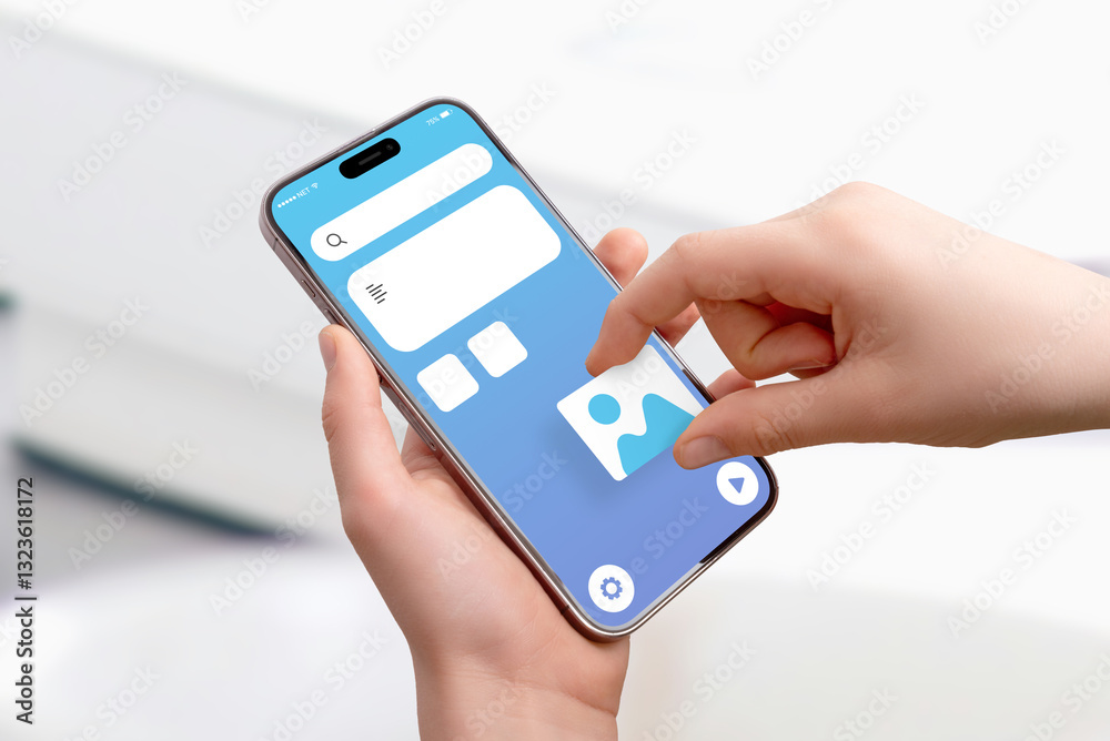 Poster Close-up of hand holding smartphone, placing picture image box on app interface, concept of drag-and-drop UI design and mobile application development
