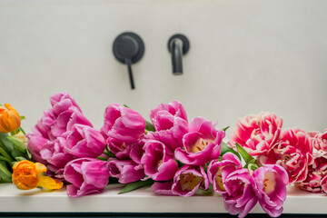 Vibrant spring tulips in a modern bathroom