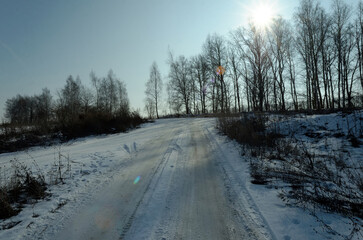 Snow-covered dirt road on a clear day