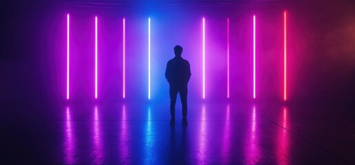 Obraz premium Man standing in front of glowing neon lights reflecting on wet floor