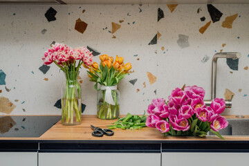 The process of caring for flowers. Trimming tulips