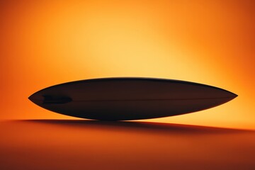 Obraz premium A streamlined surfboard appears isolated against a vibrant orange backdrop