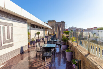 Open-air cafe on terrace with fresh flowers