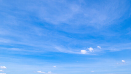 Obraz premium clear blue sky background,clouds with background, Blue sky background with tiny clouds. White fluffy clouds in the blue sky. 