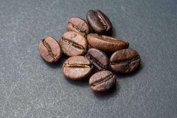 coffee in white cup and coffee beans are the background.