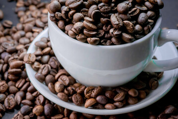 coffee in white cup and coffee beans are the background.