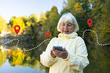 Positive elderly tourist woman searching location in map online on smartphone. Female in a yellow jacket checks her phone while walking on a forest path during autumn. High quality photo