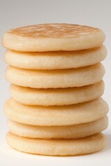 Stack of Golden Syrniki on White Background