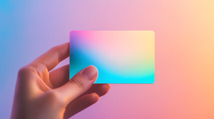 Vibrant Minimalist Hand Holding an Abstract Colorful Card Against a Soft Gradient Background
