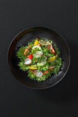 A fresh and vibrant vegetable salad, elegantly plated in a restaurant-style presentation. A mix of crisp vegetables, bright colors, and a light dressing