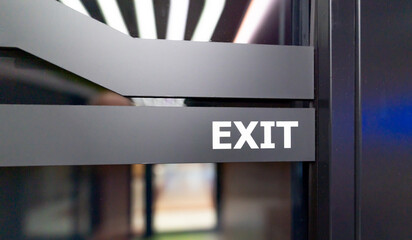 Modern exit sign on a glass door in a corporate or commercial building