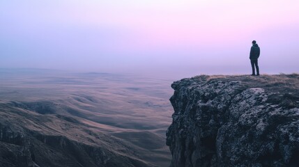 Obraz premium A lone figure gazes over endless rolling plains under a violet dawn, evoking solitude and reflection.