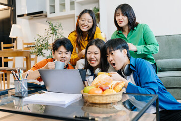 Happy group of college students excited overjoyed examination results with good news over smartphone or Laptop computer.