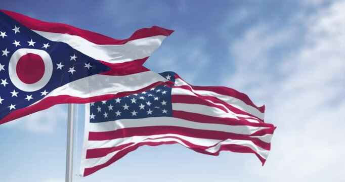 Ohio and national US flags waving in the wind on a clear day